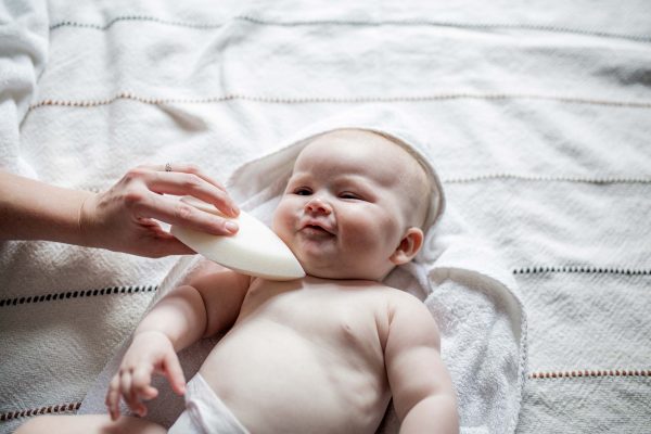 newborn small baby and a teardrop baby sponge