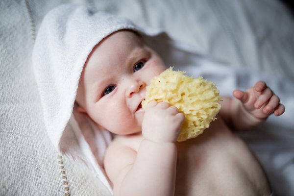 Baby care blog - A little baby with a natural sponge