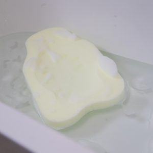 The Ellie-Fant foam bath support in a bathtub and foam