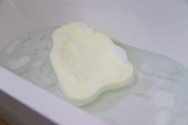 The Ellie-Fant foam bath support in a bathtub and foam