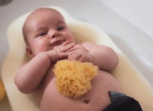 Ellie-Fant natural sea baby sponge on a newborn baby