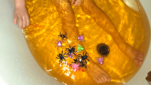 orange bath water and the colour stretchy spiders floating in it