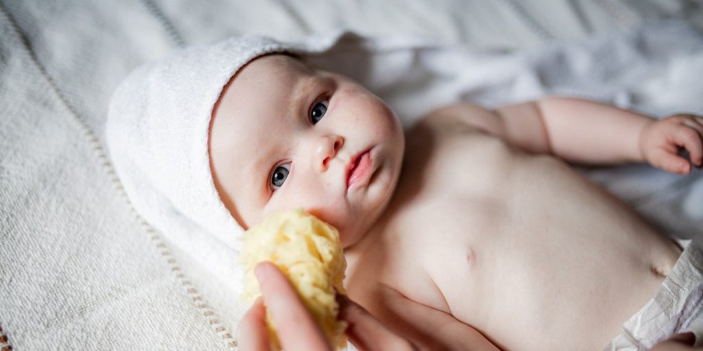 natural sea sponge on a newborn baby face